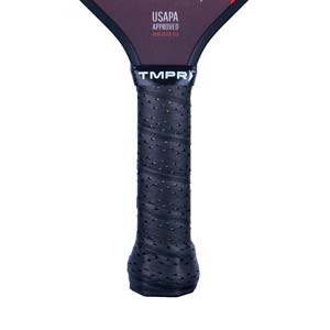 Close-up of a black pickleball paddle grip with perforations and the TMPR logo.