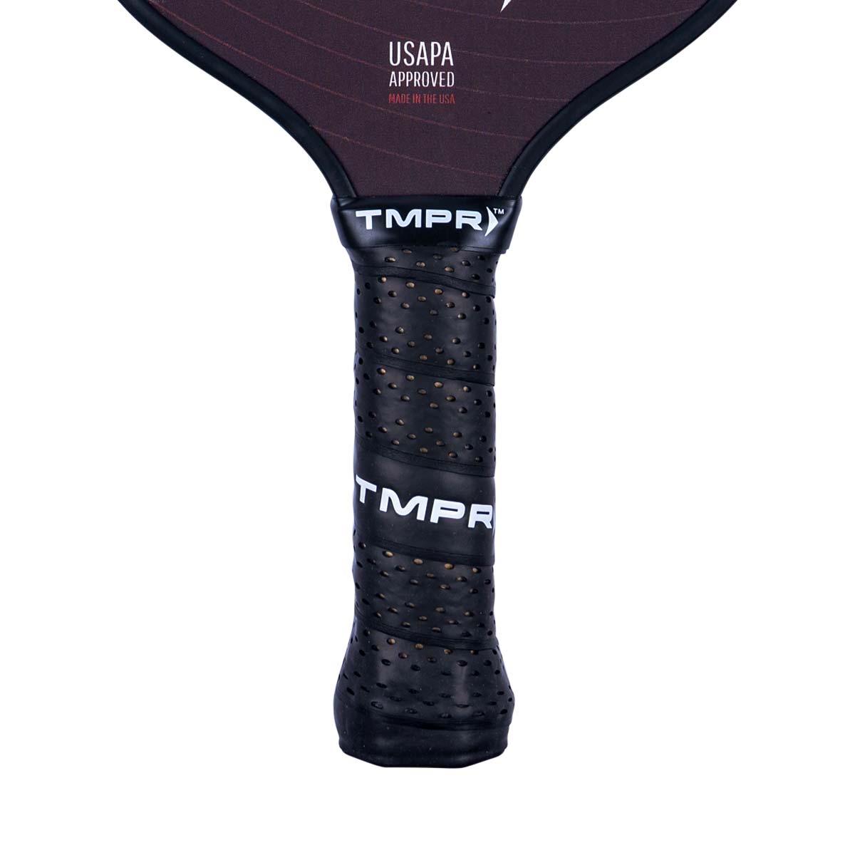 Close-up of a black pickleball paddle grip with perforated texture and TMPR branding.