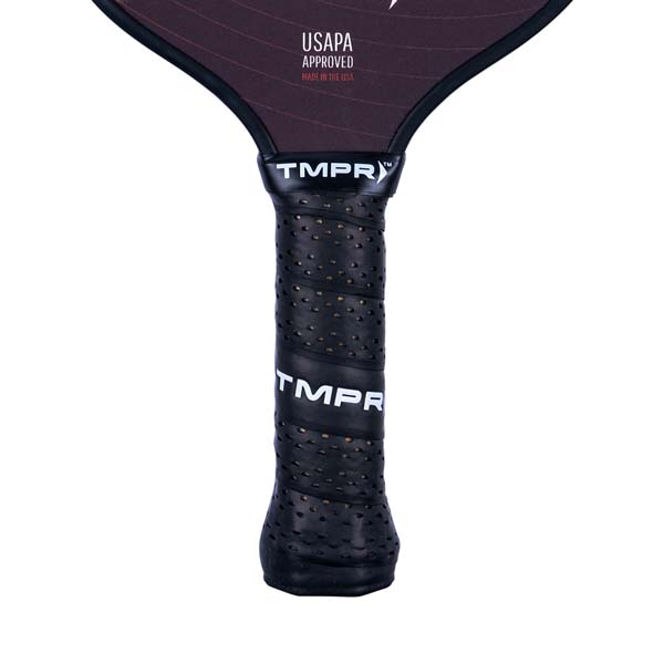 Close-up of a black pickleball paddle grip with perforated texture and TMPR branding.