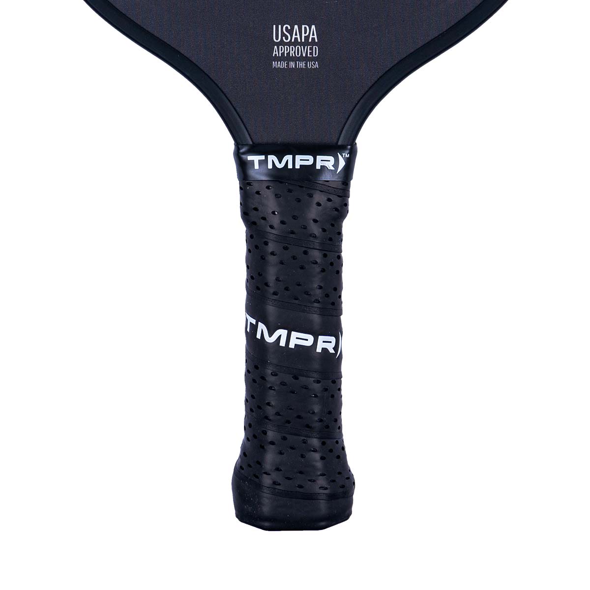 Close-up of a black pickleball paddle grip with perforations and TMPR branding.