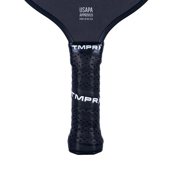 Close-up of a black pickleball paddle grip with perforations and TMPR branding.