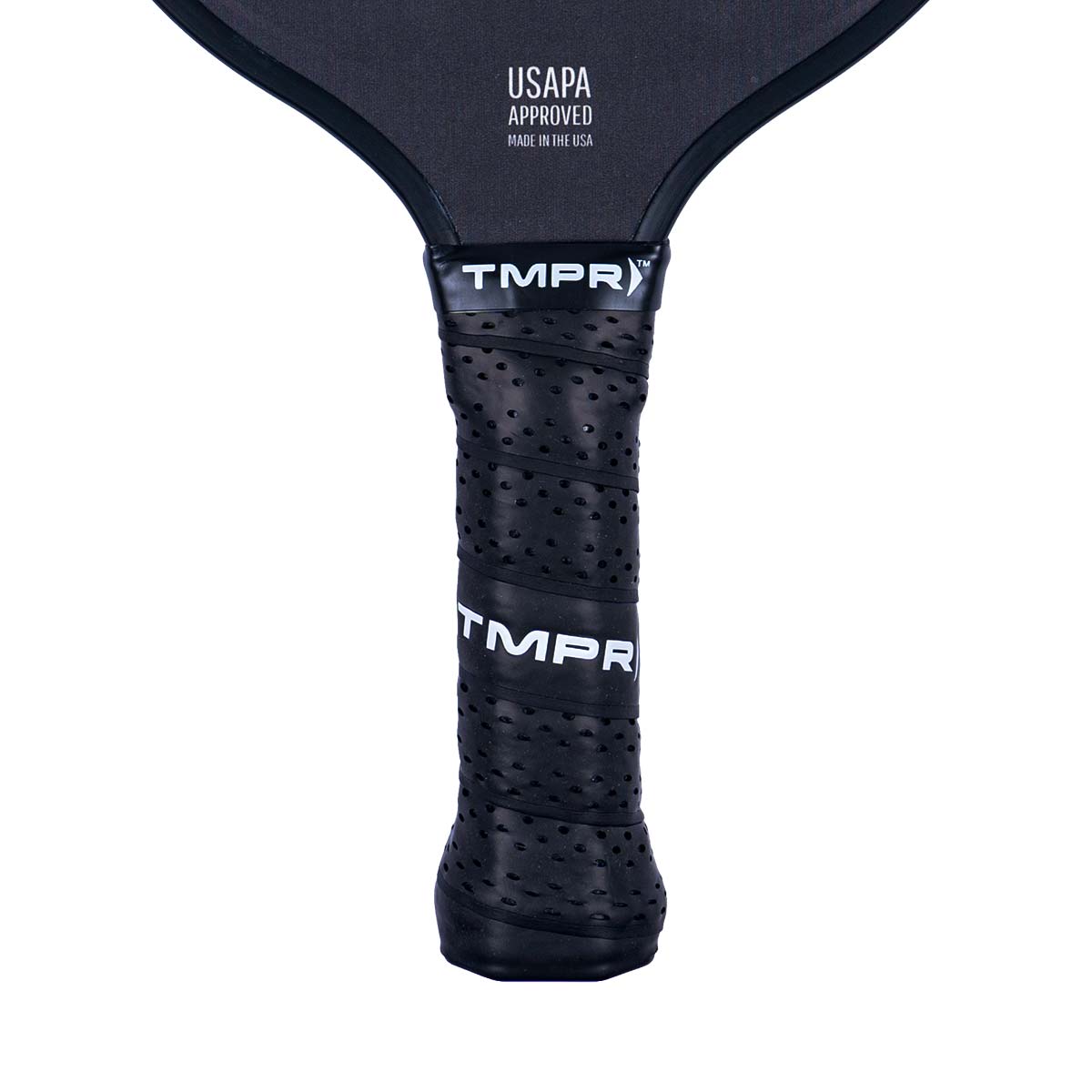 Close-up of a black pickleball paddle grip with perforations and TMPR branding.