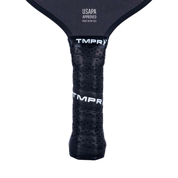 Close-up of a black pickleball paddle grip with perforations and TMPR branding.