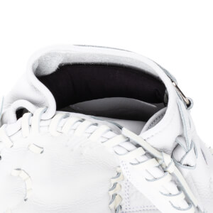 Close-up of the interior of a white baseball glove showing the pocket and lacing.