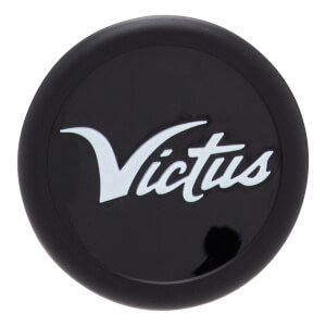 Close-up, top-down view of a black bat end cap with a raised white Victus script logo.