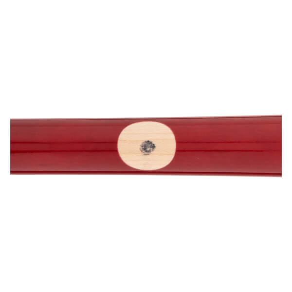 Close-up of a glossy red baseball bat with a light wood ink dot and a black mark.