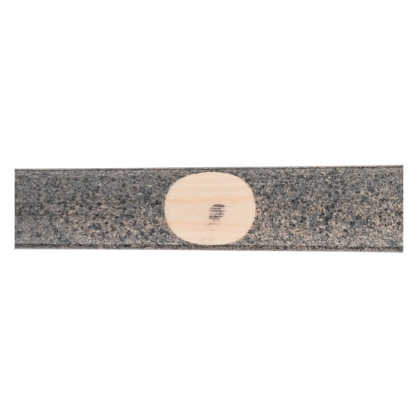 Close-up of a dark gray baseball bat with a light wood circular ink dot indicating the wood grain.