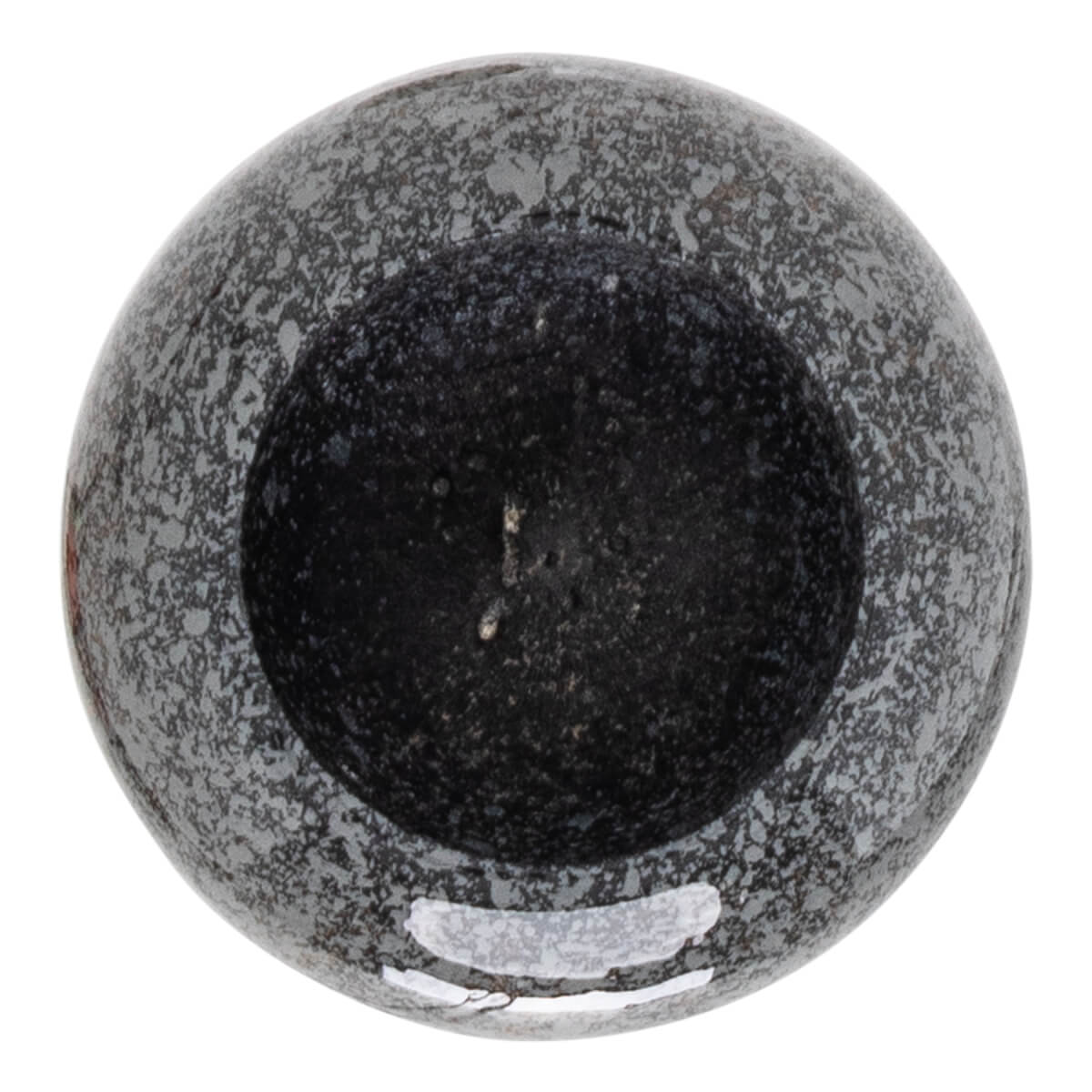 Top-down view of a speckled gray and black mortar with a dark, granular interior.
