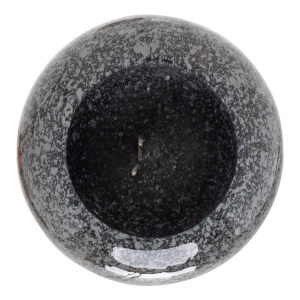 Top-down view of a speckled gray and black mortar with a dark, granular interior.