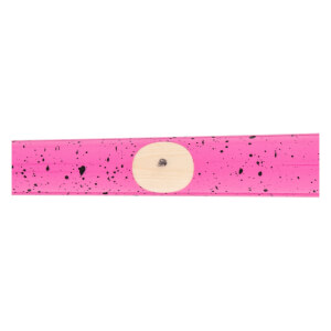Close-up of a pink baseball bat with black speckles and a circular natural wood grain ink dot.