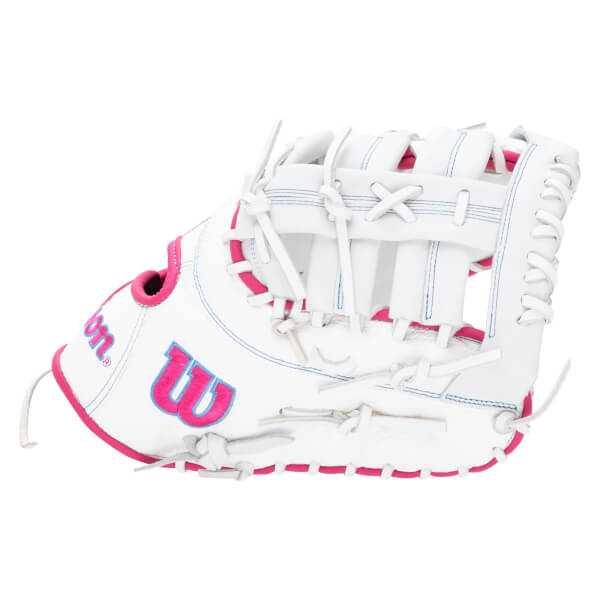 Side view of a white Wilson glove with pink trim and blue stitching, featuring a large pink "W" logo.