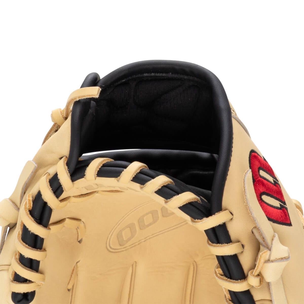 Close-up of a tan baseball glove showing black lacing and a red embroidered logo.