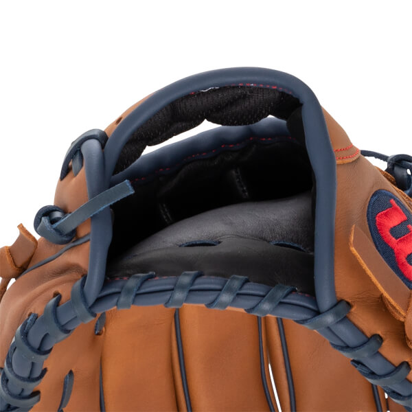 Close-up of a tan baseball glove with navy blue lacing, a black palm, and a red Wilson W logo.