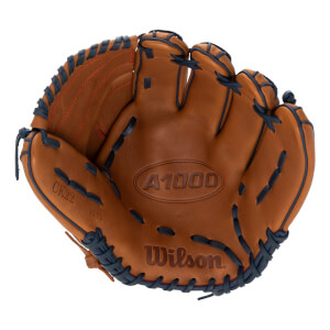 Front view of a brown baseball glove with A1000 and Wilson embossed, featuring dark blue lacing and orange stitching.