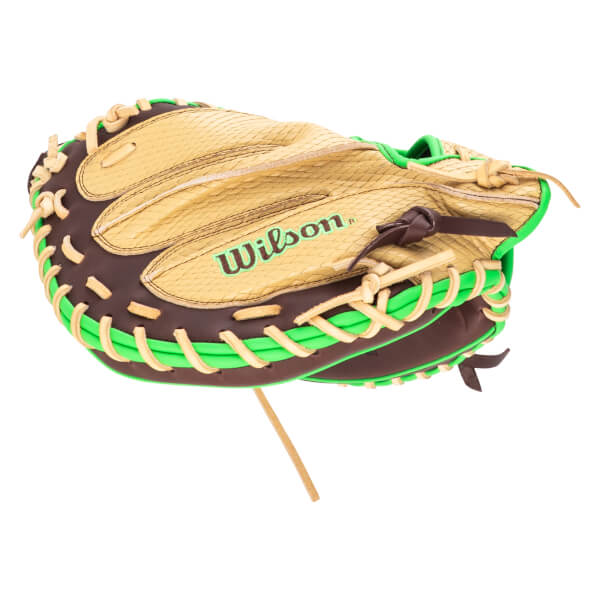 Close-up of a brown and tan baseball glove with bright green lacing and the "Wilson" logo.