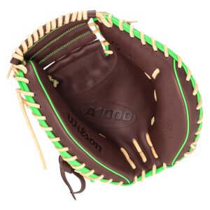 Top-down view of a brown baseball glove with bright green lacing and "A1000" and "Wilson" embossed on the palm.