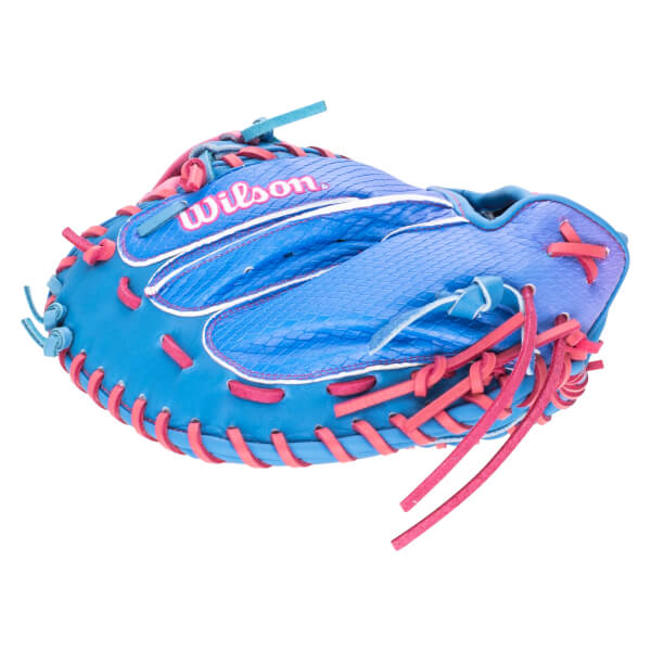 Top-down view of a blue Wilson baseball glove with pink lacing and white trim.