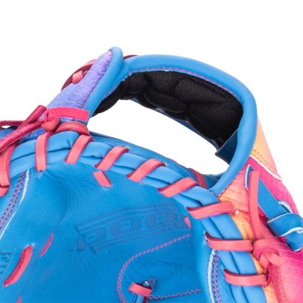 Close-up of a blue baseball glove with pink lacing and a textured purple and pink cuff.