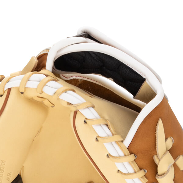 Close-up view of a baseball glove showing tan leather, white lacing, and a black padded interior.