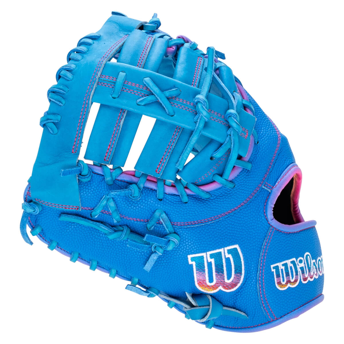 Back corner view of a bright blue baseball glove with pink stitching, featuring a large "W" logo and the word "Wilson" in a colorful gradient.