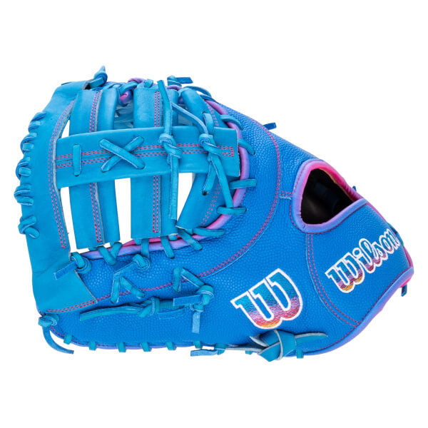 Back view of a bright blue baseball glove with pink stitching, featuring a multi-colored "W" logo and the word Wilson on the textured exterior.