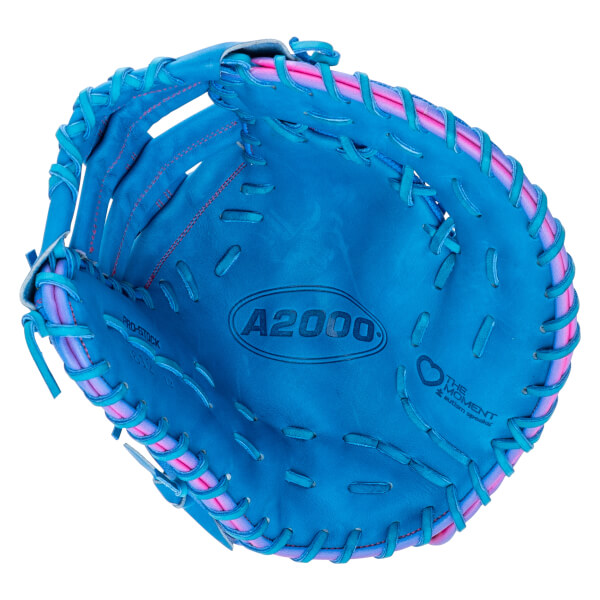 Top-down view of a bright blue baseball glove with pink and blue lacing, featuring "A2000" and "THE MOMENT autism speaks" logos stamped on the inner leather palm.
