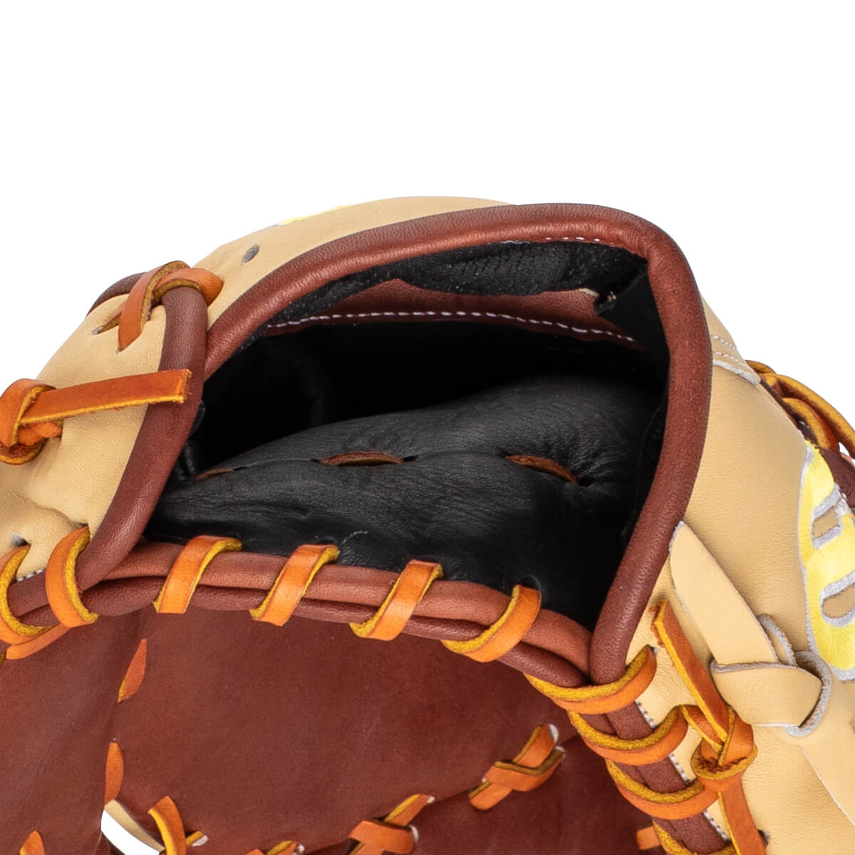 Close-up of a baseball glove's interior showing the black pocket, tan leather, and brown lacing.