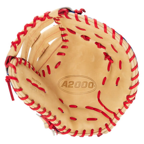 Front interior view of a tan leather first base mitt with red lacing, featuring the "A2000" logo in the palm and "PRO-STOCK" text on the thumb.