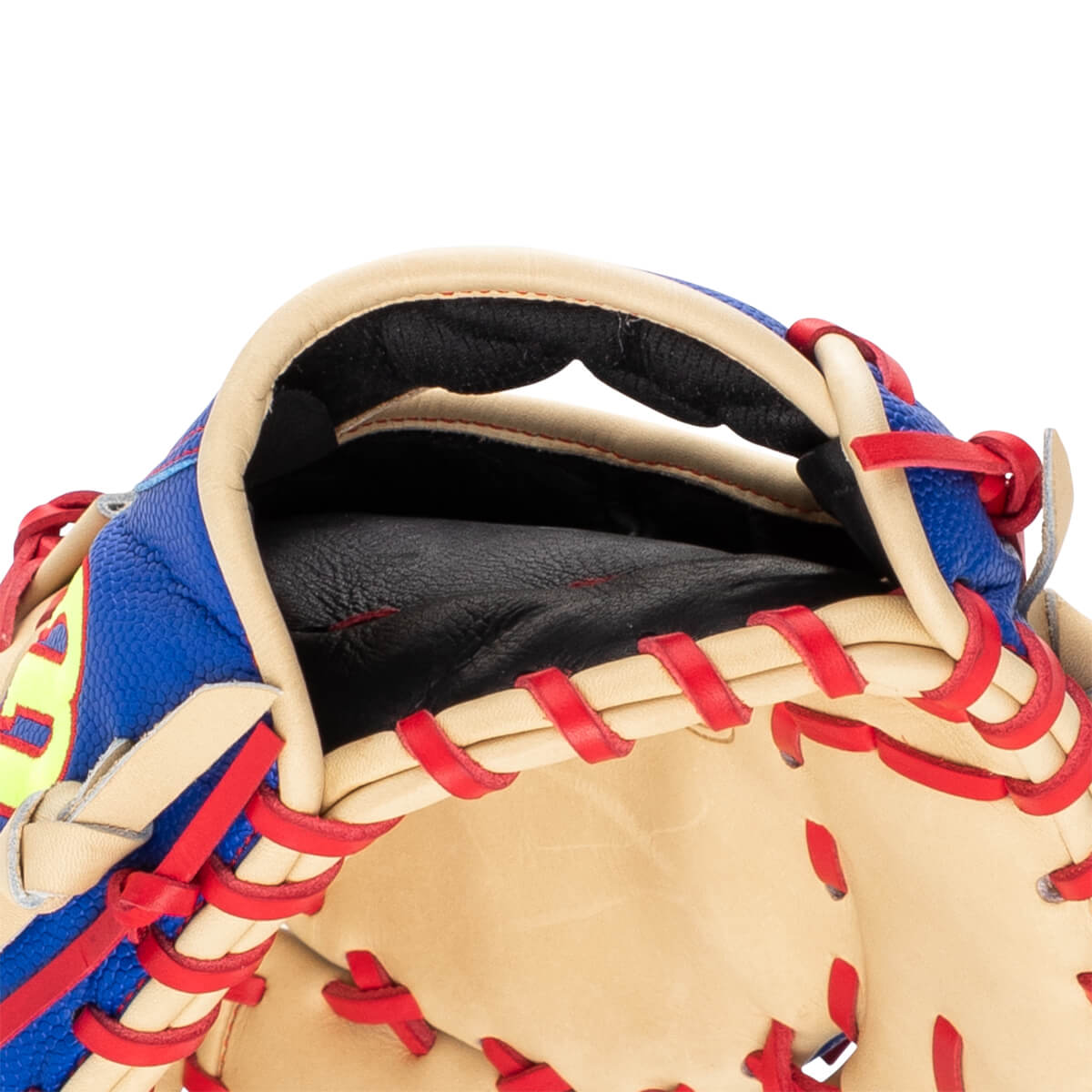 Close-up of the wrist opening on a tan and blue baseball glove featuring red lacing, a black padded interior, and a yellow Wilson logo.