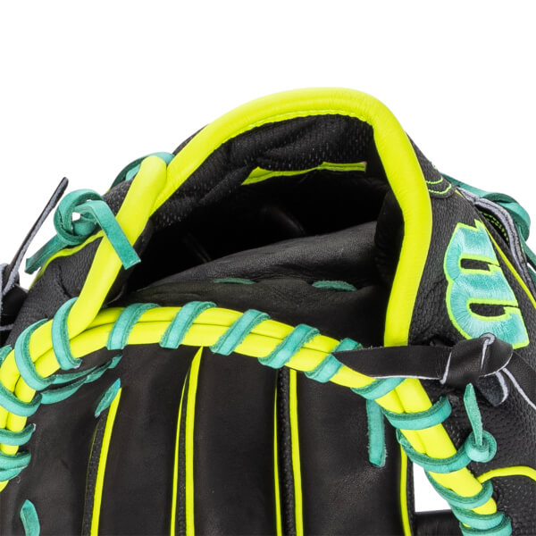 Close-up of the hand opening on a black baseball glove featuring neon yellow trim, teal laces, and a teal embroidered Wilson W logo.