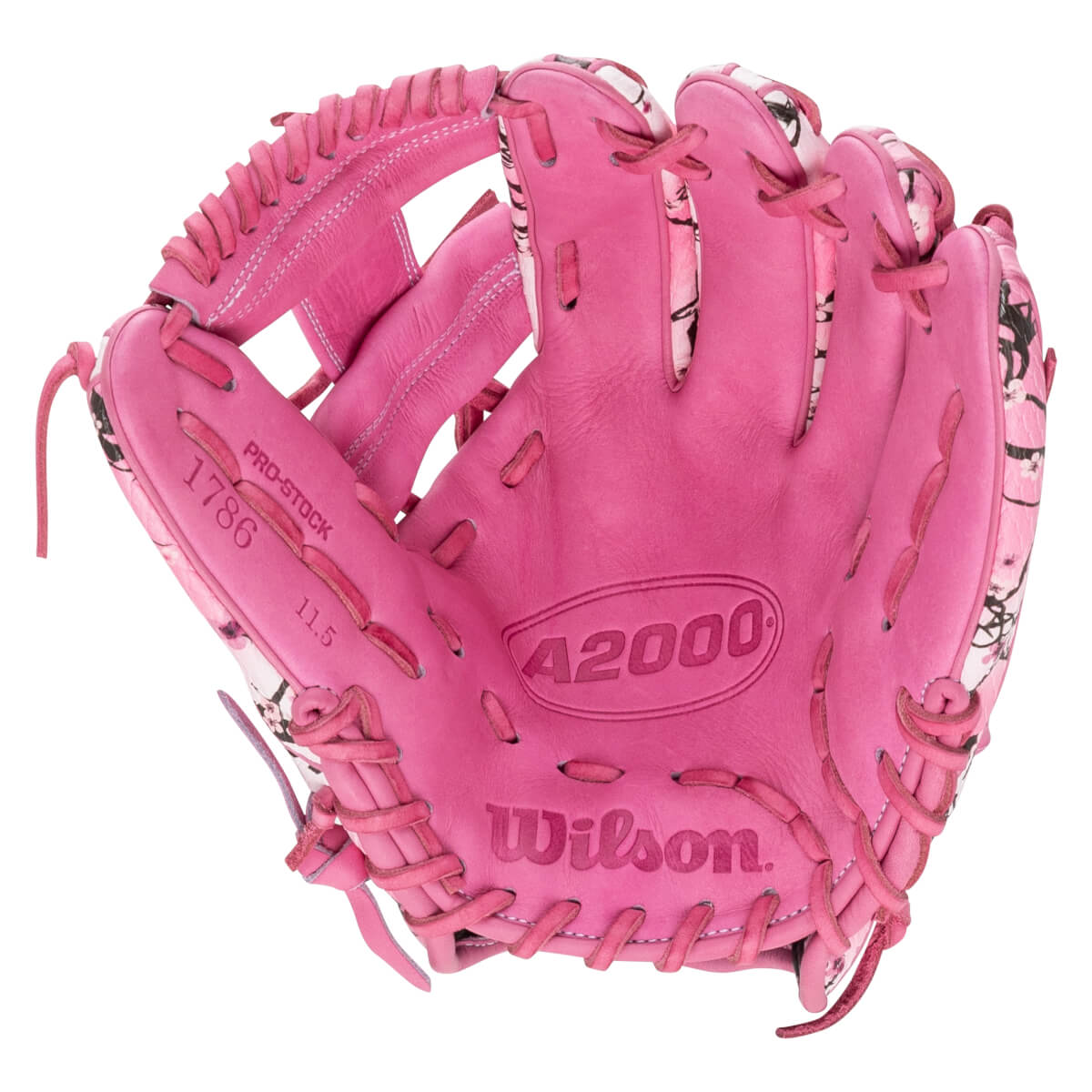 Front view of a pink Wilson A2000 baseball glove with floral accents and stamped text including Wilson, A2000, PRO-STOCK, 1786, and 11.5.