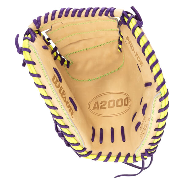 Top-down view of a tan baseball glove with purple and yellow lacing, showing the "Wilson" logo and "A2000" branding.