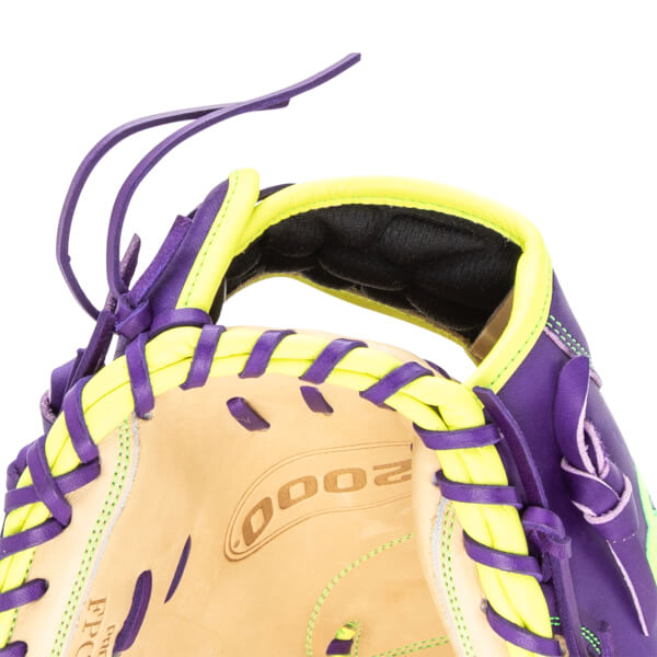 Close-up of a purple and yellow baseball glove showing the "2000" logo and "PRO" text.
