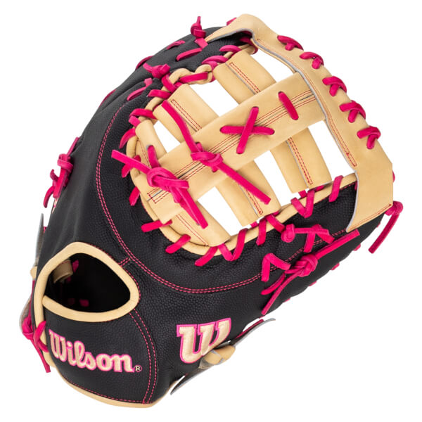 Top-down view of a black baseball glove with bright pink lacing and the "Wilson" logo.