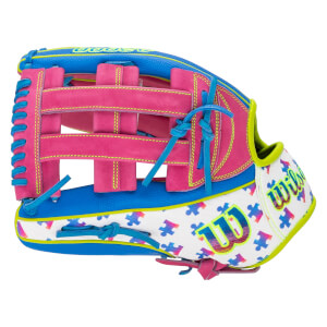Side view of the baseball glove featuring pink webbing, blue laces, and a white section with a multi-colored puzzle piece pattern and the Wilson logo.