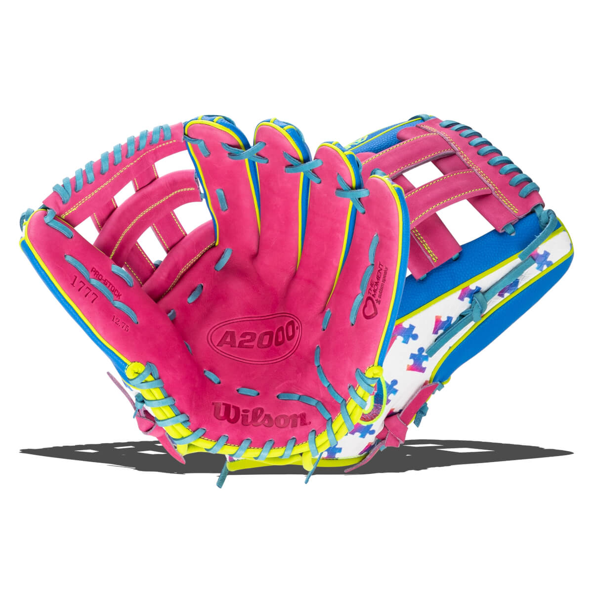 Front view of the pink glove showing the palm with blue laces, yellow binding, a puzzle piece pattern, and "A2000", "Wilson", and "Love the Moment" logos.