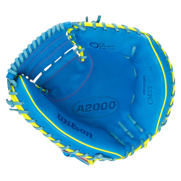 Front view of the blue catcher's mitt with yellow trim and light blue laces, featuring the "A2000," "Wilson," and "The Moment" branding on the palm.