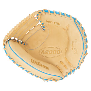 Top-down view of a tan Wilson A2000 M23 baseball glove with blue lacing and "PRO-STOCK" text.