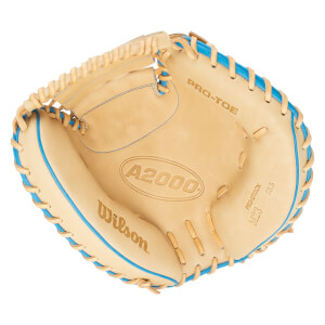 Top-down view of a tan baseball glove with blue lacing, showing "Wilson", "A2000", and "PRO-STOCK M23 33.5" text.