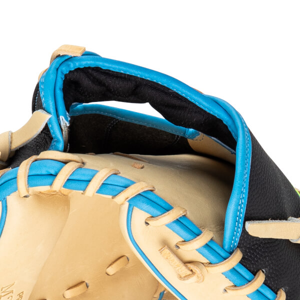 Close-up of a baseball glove's thumb and index finger area, featuring tan leather, bright blue lacing, and black textured material.
