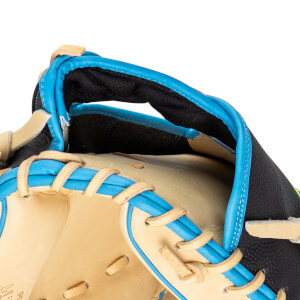 Close-up of a baseball glove's thumb and index finger area, featuring tan leather, bright blue lacing, and black textured material.