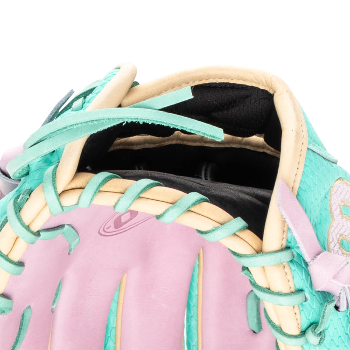 Close-up of a baseball glove's interior showing pink palm, teal lacing, and tan binding.
