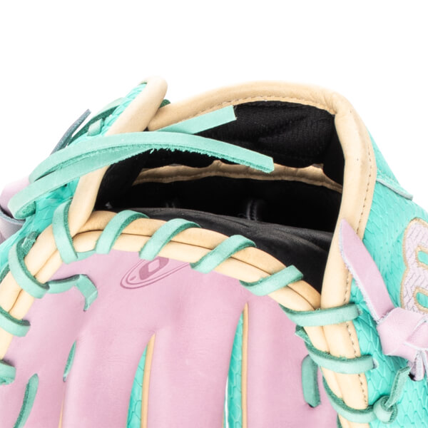 Close-up of a baseball glove's interior showing pink palm, teal lacing, and tan binding.