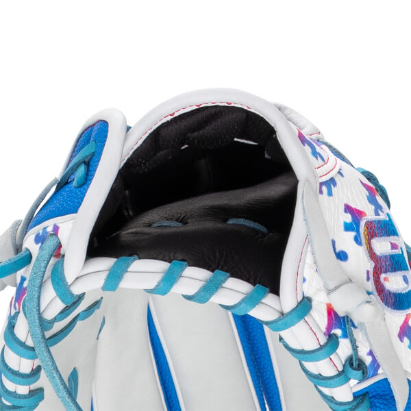 Close-up of the hand opening highlights the black leather interior, teal and white laces, and a colorful shell pattern with a partial Wilson logo.