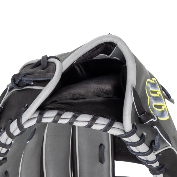 Close-up of a black and gray baseball glove showing the lacing and the yellow "GG" logo.
