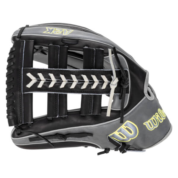 Side view of a black and gray baseball glove with yellow "A2K" and "Wilson" logos and white lacing.