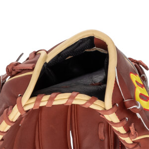 Close-up of the opening of a brown baseball glove with tan lacing and a yellow and red logo.