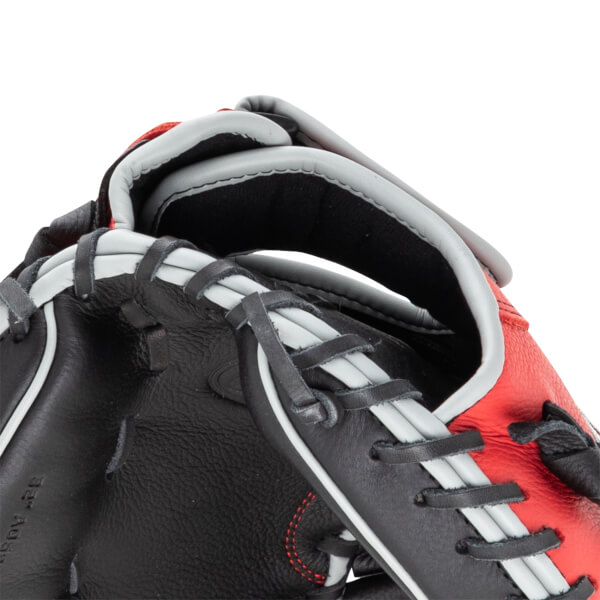 Close-up of a black and red baseball glove showing grey lacing and red stitching.