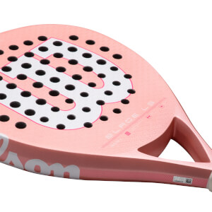 Corner view of a pink Wilson Blade LS padel racket with black dots and white lettering.