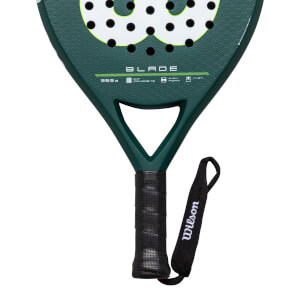 Close-up of the handle and lower head of a green Wilson Blade paddle, showing the black grip and wrist strap with "Wilson" text.